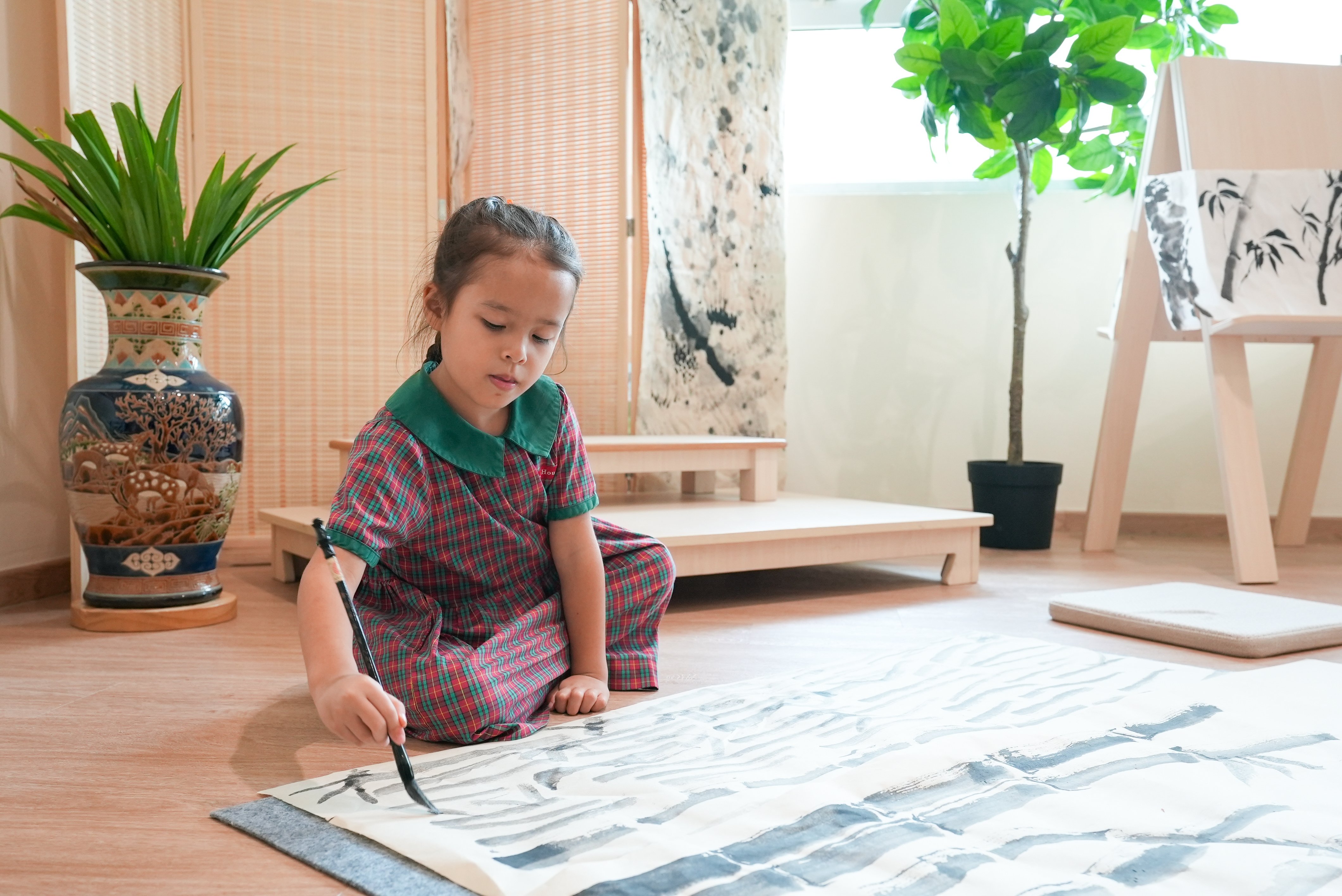 Child practising Chinese calligraphy and painting